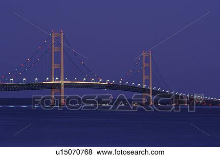 Mackinaw City, MI, Michigan, Upper Peninsula, View of Mackinac Bridge, a suspension span bridge, in the evening crosses the Straits of Mackinaw in Mackinaw City connecting the Lower Peninsula with the Upper Peninsula of Michigan. View Large Photo Image Stock Photo - Mackinaw City, MI, Michigan, Upper Peninsula, View of Mackinac Bridge, a suspension span bridge, in the evening crosses the Straits of Mackinaw in Mackinaw City connecting the Lower Peninsula with the Upper Peninsula of Michigan.. Fotosearch