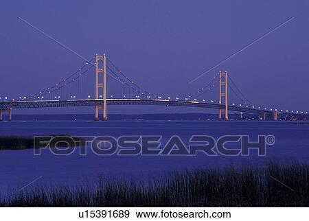 Stock Photo -  Mackinaw City, MI, Michigan, Upper Peninsula, View of Mackinac Bridge, a suspension span bridge, in the evening crosses the Straits of Mackinaw in Mackinaw City connecting the Lower Peninsula with the Upper Peninsula of Michigan.. Fotosearch
