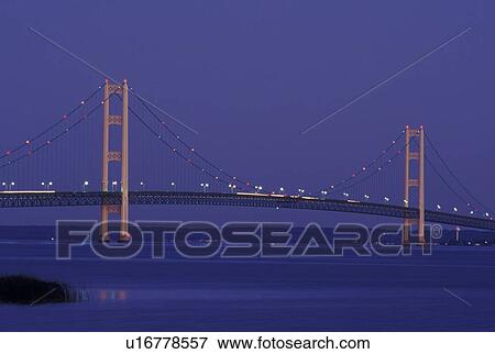 Mackinaw City, MI, Michigan, Upper Peninsula, View of Mackinac Bridge, a suspension span bridge, in the evening crosses the Straits of Mackinaw in Mackinaw City connecting the Lower Peninsula with the Upper Peninsula of Michigan. View Large Photo Image Stock Photo - Mackinaw City, MI, Michigan, Upper Peninsula, View of Mackinac Bridge, a suspension span bridge, in the evening crosses the Straits of Mackinaw in Mackinaw City connecting the Lower Peninsula with the Upper Peninsula of Michigan.. Fotosearch