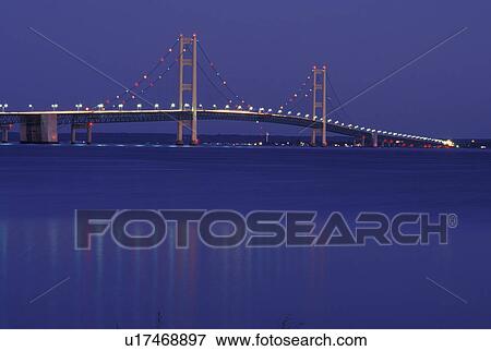 Mackinaw City, MI, Michigan, Upper Peninsula, View of Mackinac Bridge, a suspension span bridge, in the evening crosses the Straits of Mackinaw in Mackinaw City connecting the Lower Peninsula with the Upper Peninsula of Michigan. View Large Photo Image Stock Photo - Mackinaw City, MI, Michigan, Upper Peninsula, View of Mackinac Bridge, a suspension span bridge, in the evening crosses the Straits of Mackinaw in Mackinaw City connecting the Lower Peninsula with the Upper Peninsula of Michigan.. Fotosearch