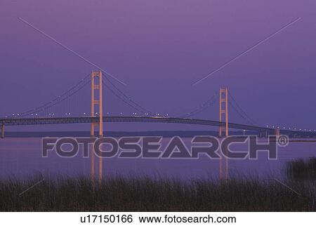 Mackinaw City, MI, Michigan, Upper Peninsula, View of Mackinac Bridge, a suspension span bridge, in the evening crosses the Straits of Mackinaw in Mackinaw City connecting the Lower Peninsula with the Upper Peninsula of Michigan. View Large Photo Image Stock Photograph - Mackinaw City, MI, Michigan, Upper Peninsula, View of Mackinac Bridge, a suspension span bridge, in the evening crosses the Straits of Mackinaw in Mackinaw City connecting the Lower Peninsula with the Upper Peninsula of Michigan.. Fotosearch
