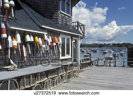 ME, Bernard, Maine, Mount Desert Island, Lobster buoys and traps on the side of a building on the pier in the harbor in the fishing village of Bernard on the Atlantic Ocean. View Large Photo Image Stock Photo - ME, Bernard, Maine, Mount Desert Island, Lobster buoys and traps on the side of a building on the pier in the harbor in the fishing village of Bernard on the Atlantic Ocean.. Fotosearch