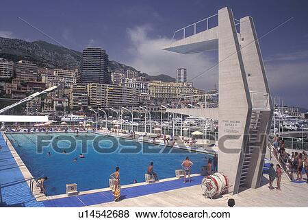Stock Photo -  Monaco, Public swimming pool on Monaco Harbor in the district of La Condamine in the Principality of Monaco along the Mediterranean Sea.. Fotosearch