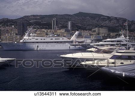 Monaco, Yachts docked in Monaco Harbor in the district of La Condamine in the Principality of Monaco along the Mediterranean Sea. View Large Photo Image Stock Image - Monaco, Yachts docked in Monaco Harbor in the district of La Condamine in the Principality of Monaco along the Mediterranean Sea.. Fotosearch