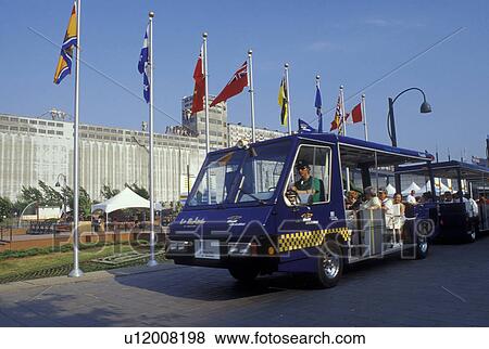 Montreal, Canada, Quebec, Tour bus shuttles passengers around the Mosaicultures internationales in Old Montreal in Quebec. View Large Photo Image Stock Photo - Montreal, Canada, Quebec, Tour bus shuttles passengers around the Mosaicultures internationales in Old Montreal in Quebec.. Fotosearch