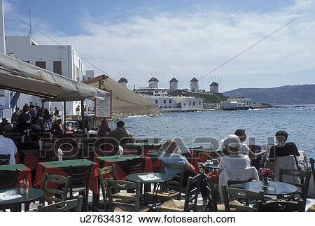 Stock Image -  Mykonos, Greek Islands, Cyclades, Greece, Europe, Outdoor cafT at Little Venice along the waterfront of Mykonos on the Aegean Sea.. Fotosearch