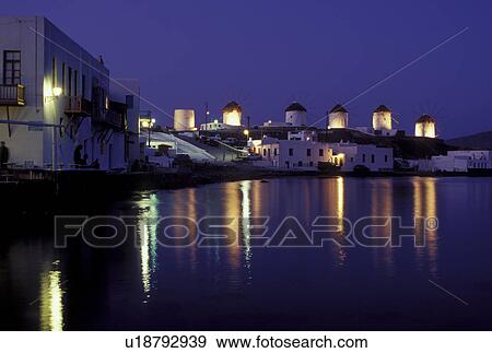 Stock Photo -  Mykonos, Greek Islands, Cyclades, Greece, Europe, Little Venice and windmills along the waterfront of Mykonos in the evening on the Aegean Sea.. Fotosearch