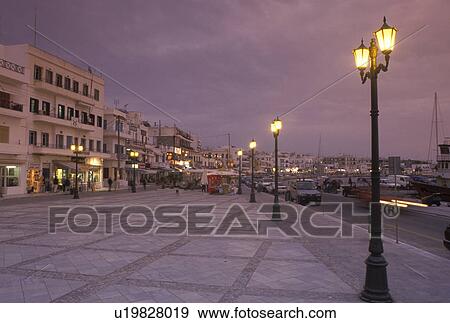 Stock Photo -  Naxos, Greece, Greek Islands, Cyclades, Europe, Waterfront on Hora Naxos Harbor in the evening on Naxos Island on the Aegean Sea.. Fotosearch