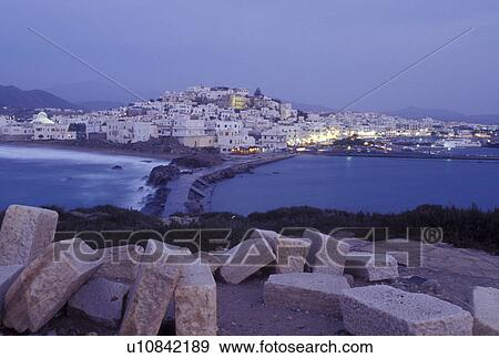 Naxos, Greek Islands, Cyclades, Greece, Europe, Scenic view of Hora Naxos and the causeway from the islet of Palatia and the Temple of Apollo on Naxos Island in the evening on the Aegean Sea. View Large Photo Image Stock Photo - Naxos, Greek Islands, Cyclades, Greece, Europe, Scenic view of Hora Naxos and the causeway from the islet of Palatia and the Temple of Apollo on Naxos Island in the evening on the Aegean Sea.. Fotosearch