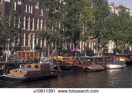 Netherlands, Amsterdam, Holland, Noord-Holland, Europe, Bike leans against railing along a canal in Amsterdam. View Large Photo Image Stock Image - Netherlands, Amsterdam, Holland, Noord-Holland, Europe, Bike leans against railing along a canal in Amsterdam.. Fotosearch