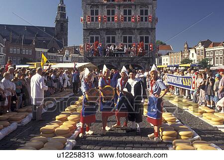 Netherlands, cheese market, Gouda, Holland, Zuid-Holland, Europe, People dressed in authentic costumes at the Cheese Market outside Town Hall on Cheese Market Day in downtown Gouda. View Large Photo Image Stock Image - Netherlands, cheese market, Gouda, Holland, Zuid-Holland, Europe, People dressed in authentic costumes at the Cheese Market outside Town Hall on Cheese Market Day in downtown Gouda.. Fotosearch