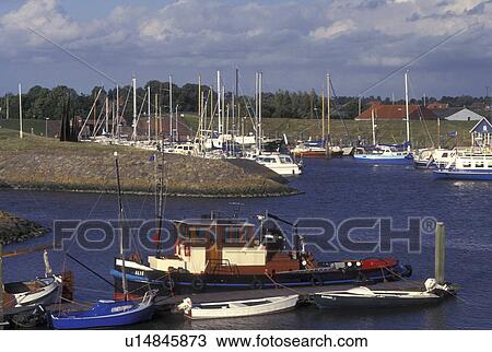 Stock Image -  Netherlands, Holland, Groningen, Termunten, Europe, Boats docked in the harbor on the North Sea in Termunten.. Fotosearch