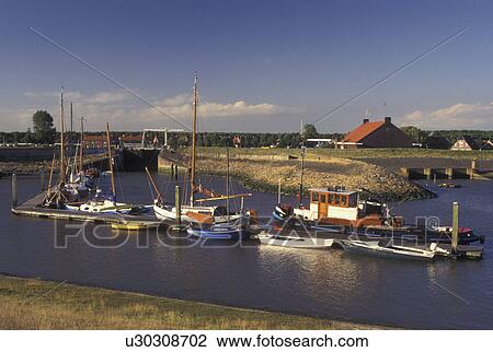 Netherlands, Holland, Groningen, Termunten, Europe, Boats docked in the harbor on the North Sea in Termunten. View Large Photo Image Stock Image - Netherlands, Holland, Groningen, Termunten, Europe, Boats docked in the harbor on the North Sea in Termunten.. Fotosearch