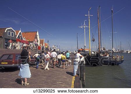 Netherlands, Holland, Volendam, Noord-Holland, Europe, People walking along the waterfront on the harbor on Markermeer in the town of Volendam. View Large Photo Image Stock Photography - Netherlands, Holland, Volendam, Noord-Holland, Europe, People walking along the waterfront on the harbor on Markermeer in the town of Volendam.. Fotosearch