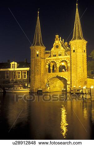Netherlands, Sneek, Holland, Friesland, Europe, Water Tower (1613) along the canal in downtown Sneek illuminated at night. View Large Photo Image Stock Photo - Netherlands, Sneek, Holland, Friesland, Europe, Water Tower (1613) along the canal in downtown Sneek illuminated at night.. Fotosearch