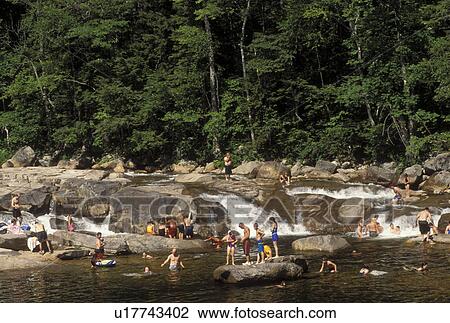 NH, New Hampshire, White Mountain National Forest, People swimming at a swimming hole on the Swift River along the Scenic Kancamagus Highway in the White Mountain Nat'l Forest. View Large Photo Image Stock Image - NH, New Hampshire, White Mountain National Forest, People swimming at a swimming hole on the Swift River along the Scenic Kancamagus Highway in the White Mountain Nat'l Forest.. Fotosearch
