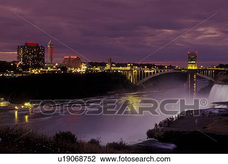 Stock Image -  Niagara Falls, Canada/USA, Ontario, NY, New York, Niagara River, Illumination at the American Falls at Niagara Falls at night.. Fotosearch