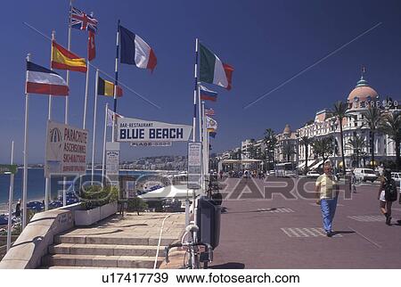 Nice, Cote d' Azur, France, Provence, Alpes-Maritimes, Europe, Outdoor restaurant along the Promenade des Anglais on the beach along the Mediterranean Sea in the city of Nice. View Large Photo Image Stock Photo - Nice, Cote d' Azur, France, Provence, Alpes-Maritimes, Europe, Outdoor restaurant along the Promenade des Anglais on the beach along the Mediterranean Sea in the city of Nice. . Fotosearch