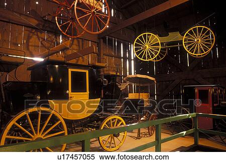 Stock Photography -  NY, New York, Mumford, Horse-drawn carriages displayed inside the Carriage Museum at Genesee Country Village & Museum. Fotosearch