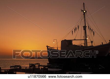 octopus, Mykonos, Greek Islands, Cyclades, Greece, Europe, Octopus drying on a fishing boat on the waterfront in Mykonos Harbor at sunset on the Aegean Sea. View Large Photo Image Stock Photograph - octopus, Mykonos, Greek Islands, Cyclades, Greece, Europe, Octopus drying on a fishing boat on the waterfront in Mykonos Harbor at sunset on the Aegean Sea.. Fotosearch
