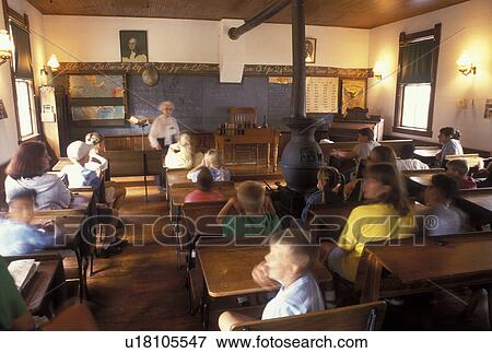 OH, Ohio, Archbold, Woman interpreter talks to visitors at the one room District 16 Schoolhouse at the Historic Sauder Farm and Craft Village. View Large Photo Image Stock Photo - OH, Ohio, Archbold, Woman interpreter talks to visitors at the one room District 16 Schoolhouse at the Historic Sauder Farm and Craft Village.. Fotosearch