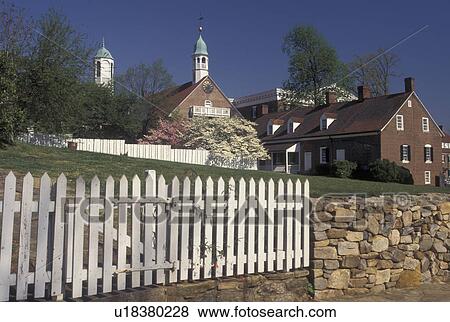 Stock Photo -  Old Salem, NC, Winston-Salem, North Carolina, Historical buildings and homes in Old Salem, a living history restoration of the Moravian Church town of Salem founded in 1766, in the spring in Winston-Salem.. Fotosearch