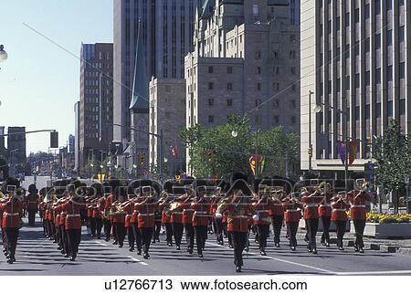 Stock Image -  Ottawa, Ontario, Canada, Marching band marches down Elgin Street during the Changing of the Guard ceremony on Parliament Hill in the capital city of Ottawa.. Fotosearch