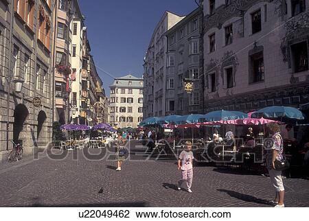 Stock Image -  outdoor cafT, Austria, Innsbruck, Tirol, Outdoor cafes along a cobbled pedestrian street in the city of Innsbruck.. Fotosearch