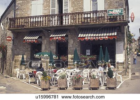 Stock Image -  outdoor cafT, France, Vezelay, Burgundy, Yonne, wine region, Bourgogne, Europe, Outdoor cafT along the street in Vezelay in the wine region of Burgundy.. Fotosearch