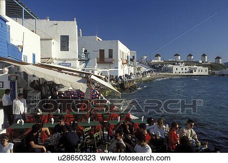 Stock Image -  outdoor cafT, Greece, Mykonos, Greek Islands, Cyclades, Europe, Outdoor cafT at Little Venice along the waterfront of Mykonos on the Aegean Sea.. Fotosearch