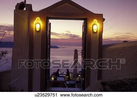 outdoor cafT, Greece, Santorini, Greek Islands, Fira, Cyclades, Europe, Outdoor cafe overlooking the Aegean Sea in the evening in the village of Fira on Santorini Island. View Large Photo Image Stock Image - outdoor cafT, Greece, Santorini, Greek Islands, Fira, Cyclades, Europe, Outdoor cafe overlooking the Aegean Sea in the evening in the village of Fira on Santorini Island.. Fotosearch