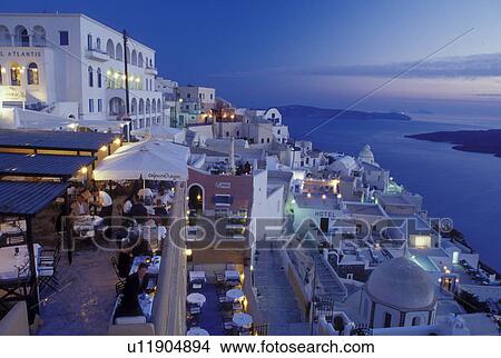 outdoor cafT, Greece, Santorini, Cyclades, Greek Islands, Fira, Europe, Outdoor restaurants and terraces in the village of Fira in the evening on the steep hillside of Santorini Island overlooking the Aegean Sea. View Large Photo Image Picture - outdoor cafT, Greece, Santorini, Cyclades, Greek Islands, Fira, Europe, Outdoor restaurants and terraces in the village of Fira in the evening on the steep hillside of Santorini Island overlooking the Aegean Sea.. Fotosearch