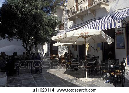Picture -  outdoor cafT, Ios, Greek Islands, Cyclades, Hora, Greece, Europe, Outdoor cafTs on the village of Hora on Ios Island on the Aegean Sea.. Fotosearch