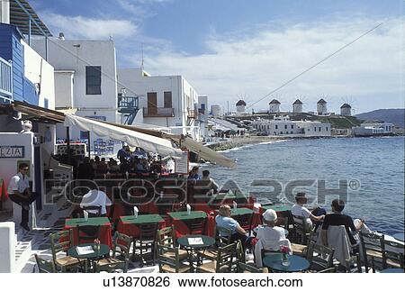 outdoor cafT, Mykonos, Greek Islands, Cyclades, Greece, Europe, Outdoor cafT at Little Venice along the waterfront of Mykonos on the Aegean Sea. View Large Photo Image Stock Photograph - outdoor cafT, Mykonos, Greek Islands, Cyclades, Greece, Europe, Outdoor cafT at Little Venice along the waterfront of Mykonos on the Aegean Sea.. Fotosearch