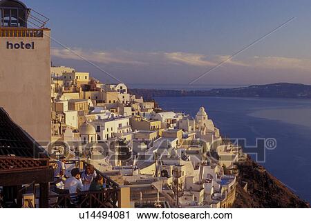 outdoor cafT, Santorini, Greece, Greek Islands, Fira, Cyclades, Europe, Outdoor restaurants and terraces in the village of Fira on the steep hillside of Santorini Island overlooking the Aegean Sea. View Large Photo Image Stock Image - outdoor cafT, Santorini, Greece, Greek Islands, Fira, Cyclades, Europe, Outdoor restaurants and terraces in the village of Fira on the steep hillside of Santorini Island overlooking the Aegean Sea.. Fotosearch