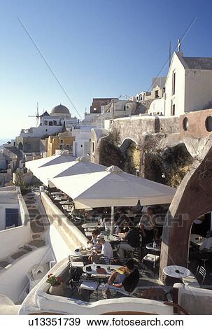 outdoor cafT, Santorini, Greece, Greek Islands, Oia, Cyclades, Europe, Outdoor restaurant in the village of Oia on the steep hillside of Santorini Island on the Aegean Sea. View Large Photo Image Stock Photo - outdoor cafT, Santorini, Greece, Greek Islands, Oia, Cyclades, Europe, Outdoor restaurant in the village of Oia on the steep hillside of Santorini Island on the Aegean Sea.. Fotosearch