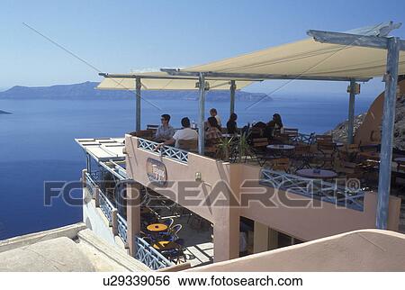 outdoor cafT, Santorini, Greece, Greek Islands, Fira, Cyclades, Europe, Outdoor restaurant overlooking the Aegean Sea in the village of Fira on Santorini Island. View Large Photo Image Stock Photograph - outdoor cafT, Santorini, Greece, Greek Islands, Fira, Cyclades, Europe, Outdoor restaurant overlooking the Aegean Sea in the village of Fira on Santorini Island.. Fotosearch