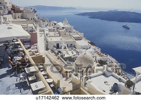 outdoor cafT, Santorini, Greek Islands, Fira, Cyclades, Greece, Europe, Outdoor restaurant in the village of Fira on the steep hillside of Santorini Island overlooking the Aegean Sea. View Large Photo Image Stock Image - outdoor cafT, Santorini, Greek Islands, Fira, Cyclades, Greece, Europe, Outdoor restaurant in the village of Fira on the steep hillside of Santorini Island overlooking the Aegean Sea.. Fotosearch