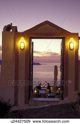 outdoor cafT, Santorini, Greek Islands, Fira, Cyclades, Greece, Europe, Outdoor cafe overlooking the Aegean Sea in the evening in the village of Fira on Santorini Island. View Large Photo Image Stock Photo - outdoor cafT, Santorini, Greek Islands, Fira, Cyclades, Greece, Europe, Outdoor cafe overlooking the Aegean Sea in the evening in the village of Fira on Santorini Island.. Fotosearch