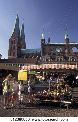 Stock Image -  outdoor market, Germany, Lubeck, Schleswig-Holstein, Europe, Market day at Markt outside City Hall in downtown Lubeck.. Fotosearch