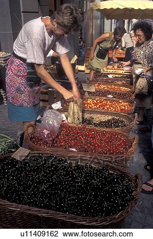 Stock Image -  outdoor market, Switzerland, Lausanne, Vaud, Cherries for sale at the open air market in the city of Lausanne.. Fotosearch