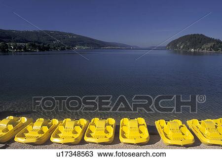Stock Image -  paddleboat, Vallee de Joux, Switzerland, Vaud, Yellow paddleboats, beach, Lac de Joux, Le Pont, Jura mountain region.. Fotosearch