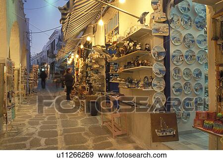 Paros, Greece, Parikia, Greek Islands, Cyclades, Greece, Europe, Shops along the narrow pedestrian streets in Plateia Mavrogenous in the evening in the town of Parikia on Paros Island. View Large Photo Image Stock Photo - Paros, Greece, Parikia, Greek Islands, Cyclades, Greece, Europe, Shops along the narrow pedestrian streets in Plateia Mavrogenous in the evening in the town of Parikia on Paros Island.. Fotosearch