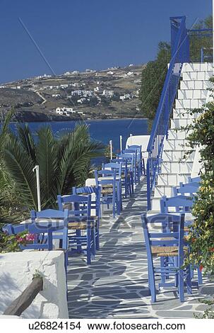Paros, Greek Islands, Greece, Parikia, Cyclades, Europe, Outdoor cafT on a terrace with whitewashed steps with blue tables and chairs in Parikia on Paros Island. View Large Photo Image Picture - Paros, Greek Islands, Greece, Parikia, Cyclades, Europe, Outdoor cafT on a terrace with whitewashed steps with blue tables and chairs in Parikia on Paros Island.. Fotosearch