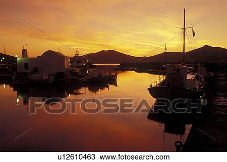 Paros, Greek Islands, Naoussa, Cyclades, Greece, Europe, Fishing boats docked on the waterfront on Naoussa Harbor at sunset on Paros Island on the Aegean Sea. View Large Photo Image Stock Image - Paros, Greek Islands, Naoussa, Cyclades, Greece, Europe, Fishing boats docked on the waterfront on Naoussa Harbor at sunset on Paros Island on the Aegean Sea.. Fotosearch