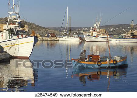 Stock Photo -  Paros, Greek Islands, Naoussa, Cyclades, Greece, Europe, Fisherman in fishing boat in Naoussa Harbor Paros Island on the Aegean Sea.. Fotosearch