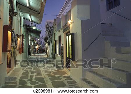 Paros, Greek Islands, Parikia, Cyclades, Greece, Europe, Shops along the narrow pedestrian streets in Plateia Mavrogenous in the evening in the town of Parikia on Paros Island. View Large Photo Image Stock Image - Paros, Greek Islands, Parikia, Cyclades, Greece, Europe, Shops along the narrow pedestrian streets in Plateia Mavrogenous in the evening in the town of Parikia on Paros Island.. Fotosearch