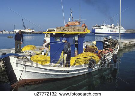 Stock Image -  Paros, Greek Islands, Parikia, Cyclades, Greece, Europe, Fishermen on fishing boat docked in the harbor of Parikia on Paros Island on the Aegean Sea.. Fotosearch