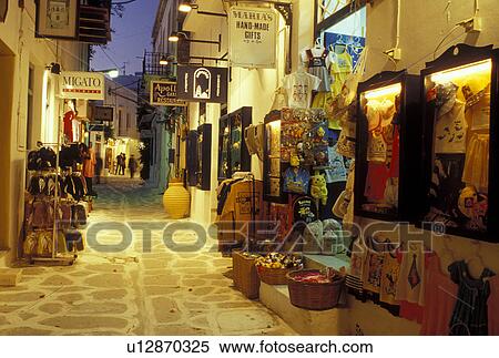 Paros, Greek Islands, Parikia, Cyclades, Greece, Europe, Shops along the narrow pedestrian streets in Plateia Mavrogenous in the evening in the town of Parikia on Paros Island. View Large Photo Image Stock Photography - Paros, Greek Islands, Parikia, Cyclades, Greece, Europe, Shops along the narrow pedestrian streets in Plateia Mavrogenous in the evening in the town of Parikia on Paros Island.. Fotosearch