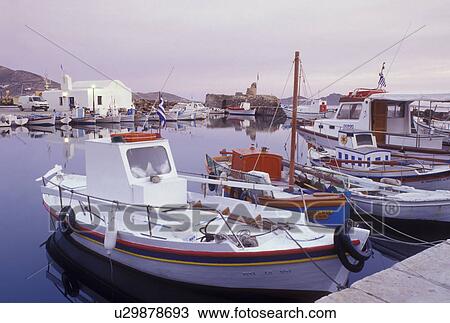 Stock Image -  Paros, Naoussa, Greece, Greek Islands, Cyclades, Europe, Fishing boats docked on the waterfront on Naoussa Harbor on Paros Island on the Aegean Sea.. Fotosearch